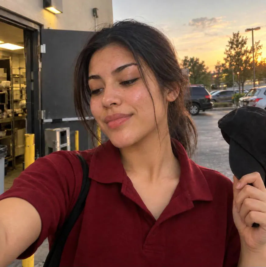 The same girl after her shift with clear skin, smiling